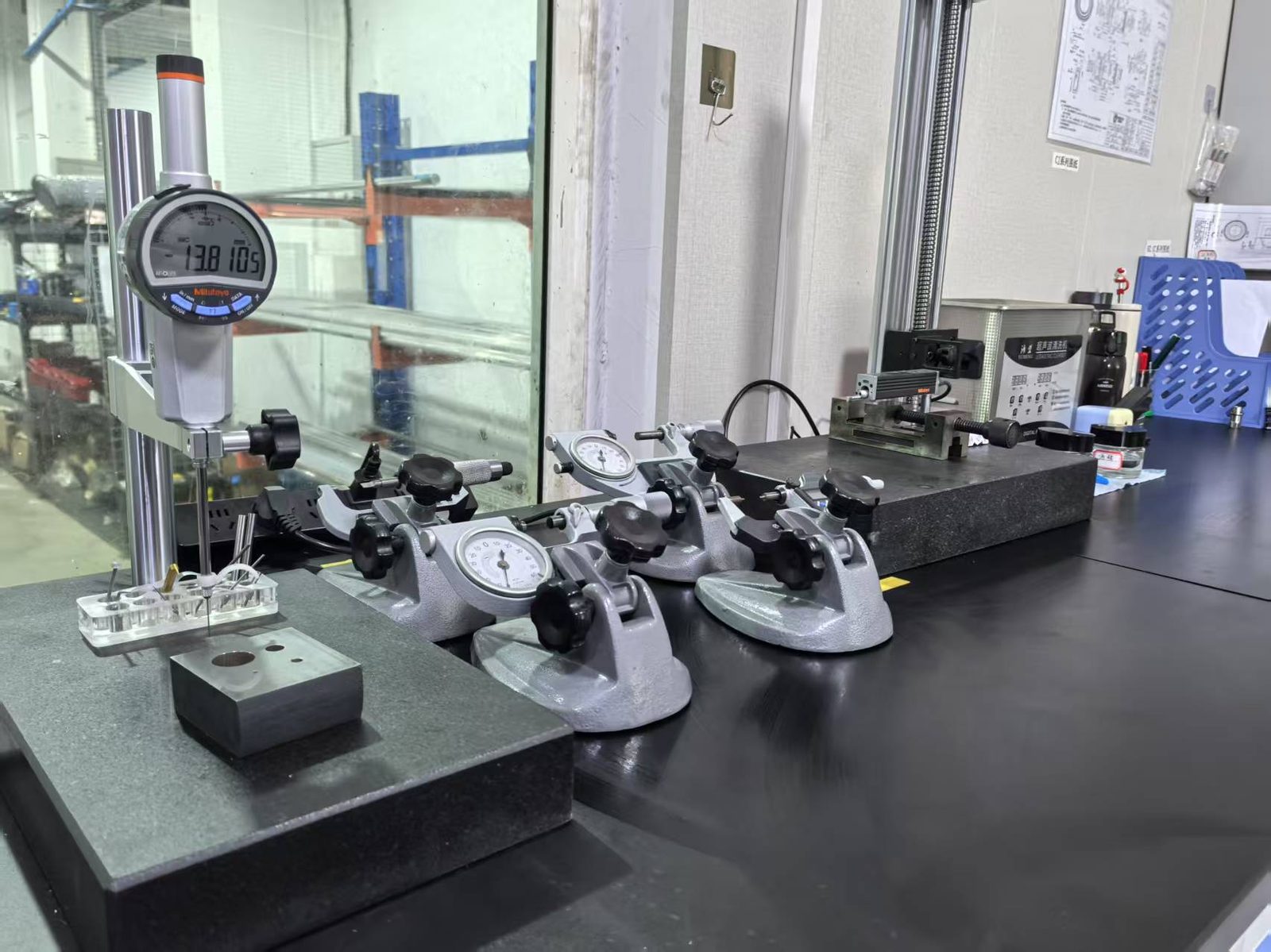Mitutoyo height gauge, dial indicators and lever-type micrometers on the inspection bench